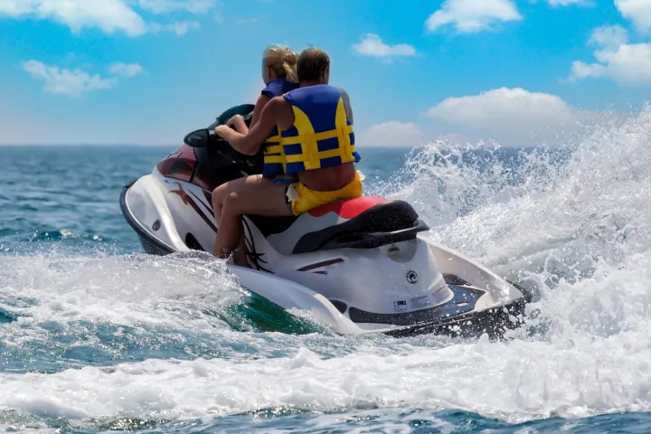 a man riding a wave on top of a body of water