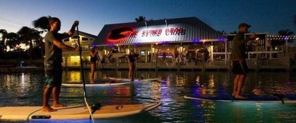 a person standing next to a body of water