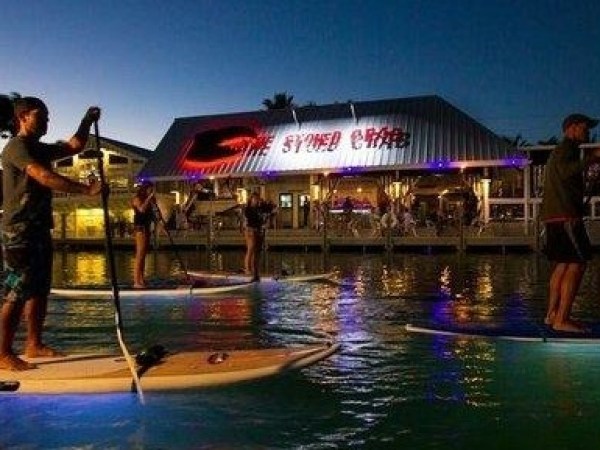 a person standing next to a body of water