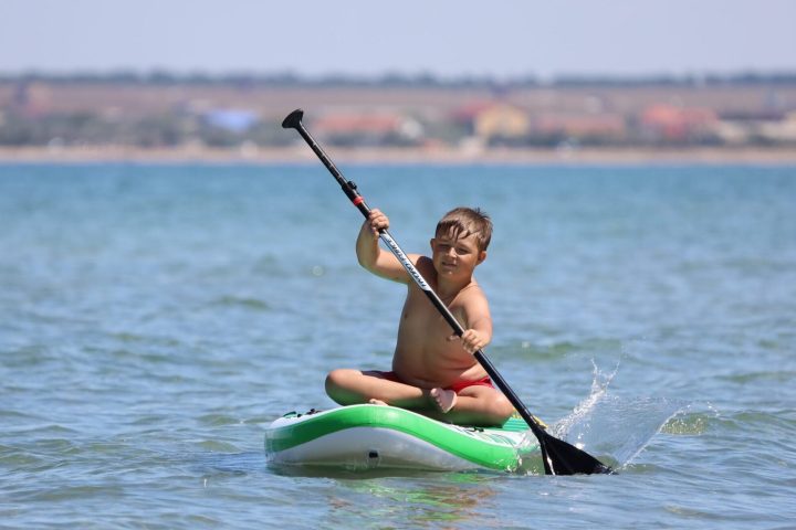 a person riding a surf board on a body of water